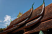 Wat Xieng Thong temple in Luang Prabang, Laos.  Detail of the sweeping roof of the 'sim'. 